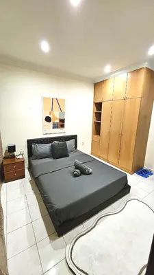 a bedroom with a large bed in a room at Cozy 2 Private Rooms in Taman Desa with Shared Bathroom in Kuala Lumpur