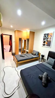 a bedroom with two beds and a living room at Cozy 2 Private Rooms in Taman Desa with Shared Bathroom in Kuala Lumpur