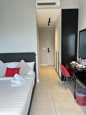 a bedroom with a bed and a desk with a computer at Axon Suites near at Pavilion with Rooftop Panoramic City View in Kuala Lumpur