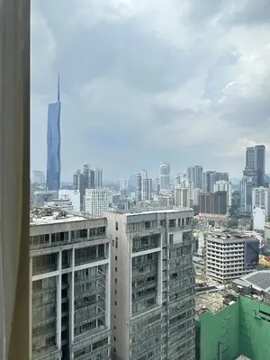 a view of a city skyline with a tall skyscraper at Axon Suites near at Pavilion with Rooftop Panoramic City View in Kuala Lumpur