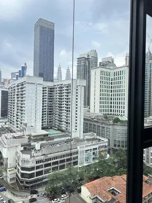 a view of a city skyline from a window at Axon Suites near at Pavilion with Rooftop Panoramic City View in Kuala Lumpur