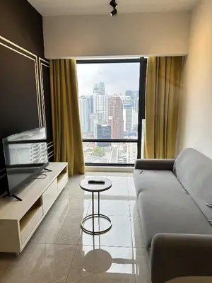 a living room with a couch and a large window at Axon Suites near at Pavilion with Rooftop Panoramic City View in Kuala Lumpur