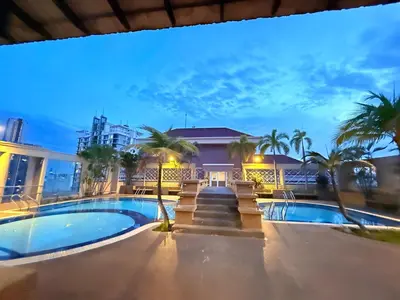 a villa with a swimming pool at night at CozyHome Suites Casa Mutiara in Kuala Lumpur