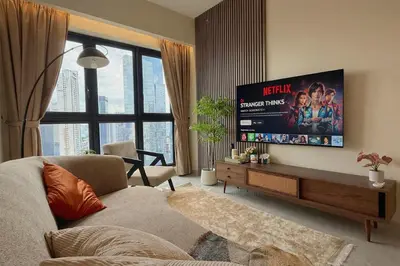a living room with a couch and a flat screen tv at 5PX Comfy 2BR Agile Bukit Bintang Walkable Pavilion, TRX & MRT in Kuala Lumpur