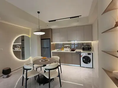 a kitchen with a table and chairs in a room at 5PX Comfy 2BR Agile Bukit Bintang Walkable Pavilion, TRX & MRT in Kuala Lumpur