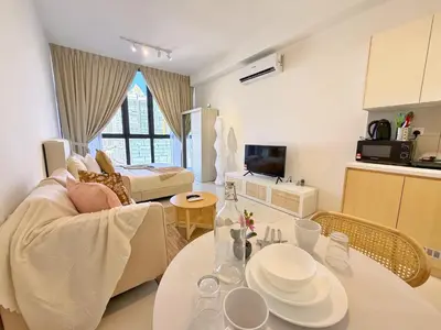 a living room with a couch and a table at Majestic Charming Studio Suite with Infinity Pool in Kuala Lumpur