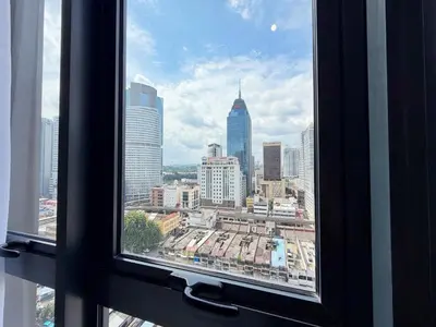 a view of a city skyline from a window at Majestic Charming Studio Suite with Infinity Pool in Kuala Lumpur
