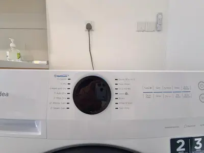 a close up of a washing machine at Majestic Charming Studio Suite with Infinity Pool in Kuala Lumpur