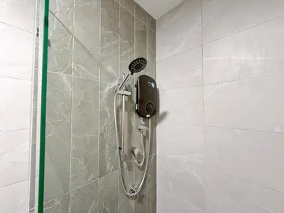 a shower in a bathroom with a phone on the wall at Majestic Modern Studio Suites with Infinity Pool in Kuala Lumpur