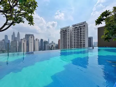 a large swimming pool on top of a city skyline at Majestic Modern Studio Suites with Infinity Pool in Kuala Lumpur