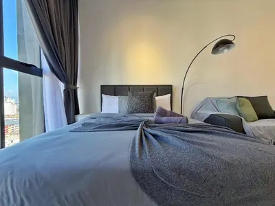 a bedroom with a large bed with a large window at Majestic Modern Studio Suites with Infinity Pool in Kuala Lumpur