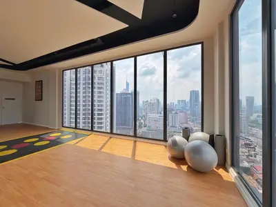 a room with a large window with a view of a city at Majestic Modern Studio Suites with Infinity Pool in Kuala Lumpur