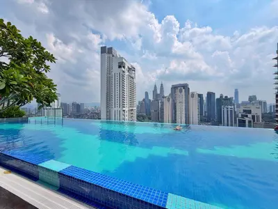 a large swimming pool on top of a city skyline at Majestic Modern Studio Suites with Infinity Pool in Kuala Lumpur