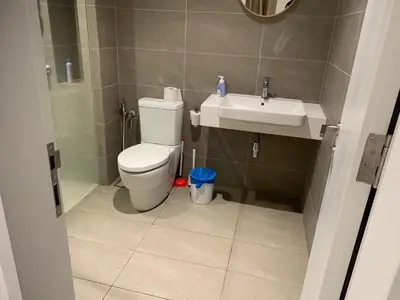 a bathroom with a toilet and a sink at Premier suites at Quill Residence KL in Kuala Lumpur