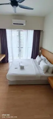 a bedroom with a large bed with a ceiling fan at Greenstone suites at Seri Bukit Ceylon in Kuala Lumpur
