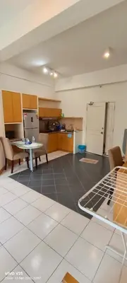 a living room with a kitchen and a table at Greenstone suites at Seri Bukit Ceylon in Kuala Lumpur