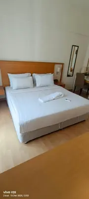 a bedroom with a large bed with white sheets at Greenstone suites at Seri Bukit Ceylon in Kuala Lumpur