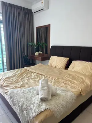 a bedroom with a large bed with towels on it at Ampang 2pax Studio Ampang Point in Ampang