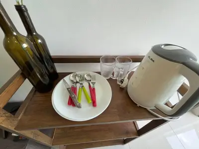 a table with a plate and a toaster and wine glasses at Ampang 2pax Studio Ampang Point in Ampang