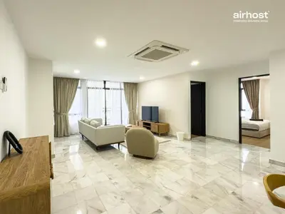 a living room with a couch and a tv at Villa Putra Condo PWTC by Airhost in Kuala Lumpur