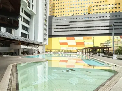 a swimming pool in the middle of a building at Villa Putra Condo PWTC by Airhost in Kuala Lumpur