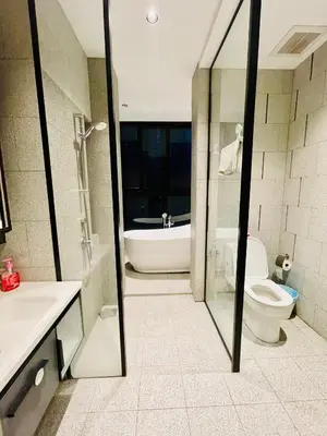 a bathroom with a tub and a toilet and a sink at Scarletz Residence KLCC Rooftop Pool in Kuala Lumpur