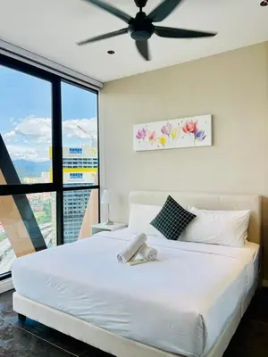 a bedroom with a white bed with a ceiling fan at Scarletz Residence KLCC Rooftop Pool in Kuala Lumpur