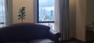 a living room with a couch and a window at Relax Suite Times Square Kl in Kuala Lumpur