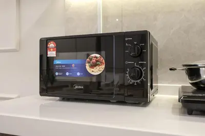 a microwave on a counter with a bowl of food in it at Agile Bukit Bintang By NexxField in Kuala Lumpur