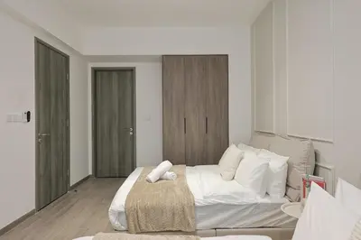 a white bedroom with a large bed with white pillows at Agile Bukit Bintang By NexxField in Kuala Lumpur