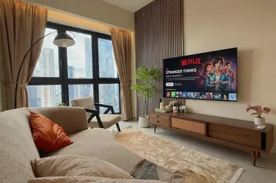 a living room with a couch and a flat screen tv at 3PX Deluxe Suites Agile Bukit Bintang, Walkable Pavilion & TRX & MRT in Kuala Lumpur