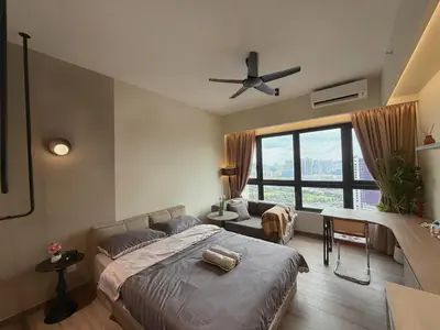 a bedroom with a bed and a desk and a window at 2PX Comfy Suite, Agile Bukit Bintang Near TRX, Pavilion, MRT TRX in Kuala Lumpur