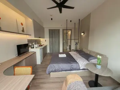 a bedroom with a large bed and a kitchen at 2PX Comfy Suite, Agile Bukit Bintang Near TRX, Pavilion, MRT TRX in Kuala Lumpur