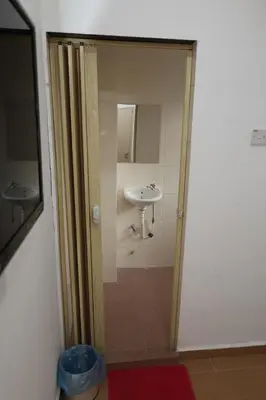 a bathroom with a sink and a shower backdoor at Haven Hotel Pudu in Kuala Lumpur