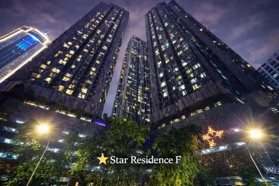 two tall buildings in a city at night at The Global Star Residences At KLCC in Kuala Lumpur
