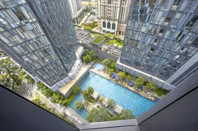 an overhead view of a pool between two tall buildings at The Global Star Residences At KLCC in Kuala Lumpur