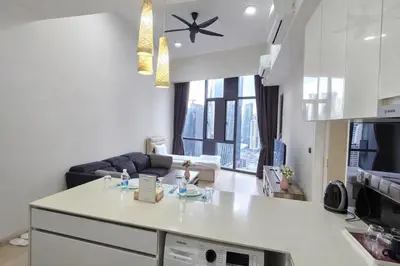 a kitchen and living room with a white counter top at The Global Star Residences At KLCC in Kuala Lumpur