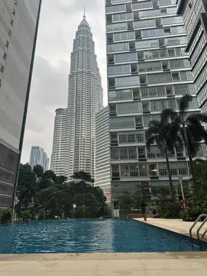 a pool in front of some tall buildings at KLCC Marc Residence by Sadz in Kuala Lumpur