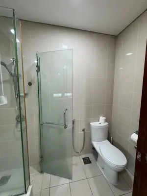 a bathroom with a toilet and a glass shower at KLCC Marc Residence by Sadz in Kuala Lumpur