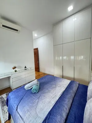 a bedroom with a blue bed and a sink at KLCC Marc Residence by Sadz in Kuala Lumpur