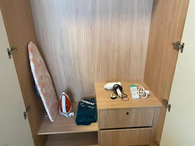 a wooden cabinet with a surfboard on top of it at Kampung Marsa at Majestic Residence, Kuala Lumpur in Kuala Lumpur