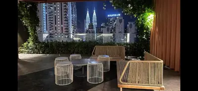 a table and chairs with a view of a city at Kampung Marsa at Majestic Residence, Kuala Lumpur in Kuala Lumpur