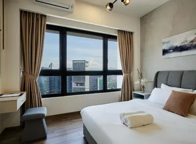 a bedroom with a bed and a large window at City Haven Bukit Bintang,KLCC,Pavillion in Kuala Lumpur