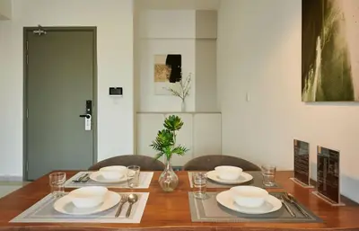 a dining room table with plates and bowls on it at City Haven Bukit Bintang,KLCC,Pavillion in Kuala Lumpur