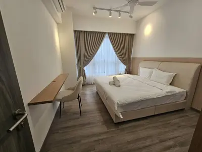 a bedroom with a bed and a desk and a window at City Haven Bukit Bintang,KLCC,Pavillion in Kuala Lumpur