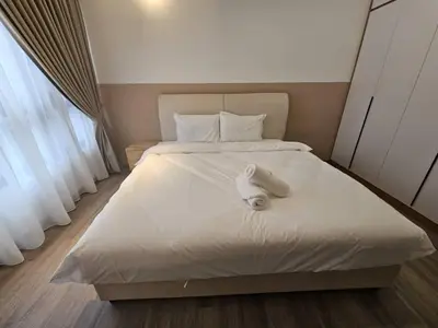 a bed with a white towel on top of it at City Haven Bukit Bintang,KLCC,Pavillion in Kuala Lumpur
