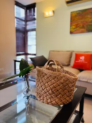 a rattan basket sitting on a glass table in a living room at 183 Ampang KLCC by Widebed in Kuala Lumpur