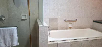 a bathroom with a bath tub and a shower at B Service apartment times Square kl in Kuala Lumpur
