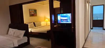 a bedroom with a bed and a tv and a mirror at B Service apartment times Square kl in Kuala Lumpur