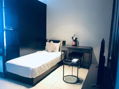 a small bedroom with a bed and a desk at Axon Residence Glaxay Suite Bukit Bintang KL in Kuala Lumpur